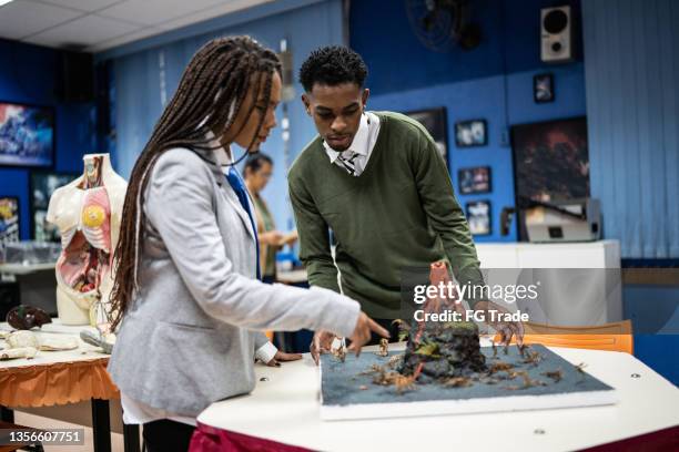 teenager students working on a school science project in the classroom - chemistry model stock pictures, royalty-free photos & images