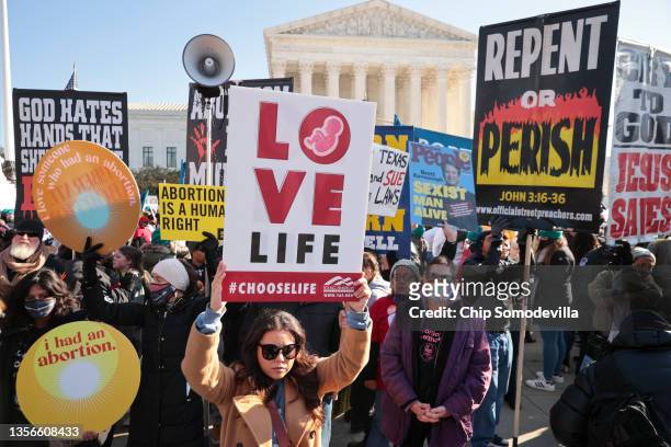 Demonstrators gather in front of the U.S. Supreme Court as the justices hear arguments in Dobbs v. Jackson Women's Health, a case about a Mississippi...