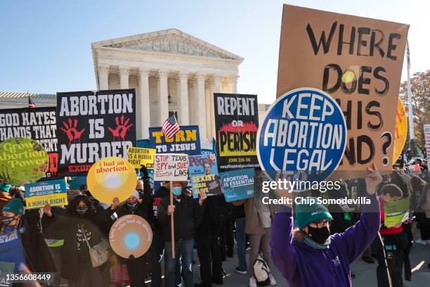 Demonstrators gather in front of the U.S. Supreme Court as the justices hear arguments in Dobbs v. Jackson Women's Health, a case about a Mississippi...