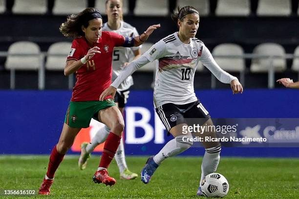 Dolores Silva of Portugal challenges Dzenifer Marozsan of Germany during the FIFA Women's World Cup 2023 Qualifier group H match between Portugal and...