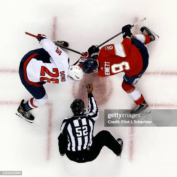 Linesmen Shandor Alphonso drops the puck for a face off between Nic Dowd of the Washington Capitals and Sam Bennett of the Florida Panthers at the...