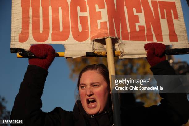 An anti-abortion demonstrator hurls insults at pro-choice activists in front of the U.S. Supreme Court as the justices hear hear arguments in Dobbs...
