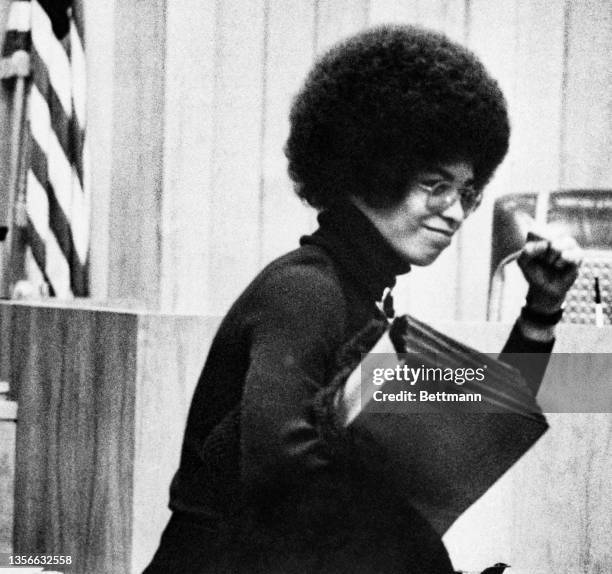 Angela Davis salutes the spectators at the pretrial hearing at the Santa Clara County Superior Court. Final arguments were to be given at the hearing.