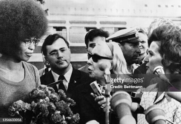 Angela Davis listens as interpreter translates greetings of Valentina Tereshkova , the Soviet Union's only female cosmonaut. Davis, arriving here,...