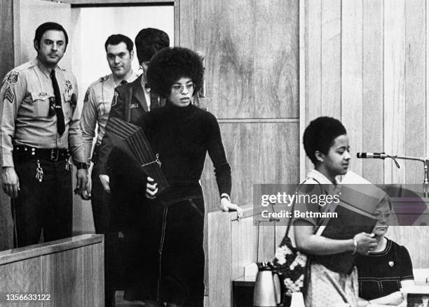 Led by one of her attorney's, Margaret Burnham, Angela Davis, , enters the courtroom where prosecution and defense presented arguments in the final...