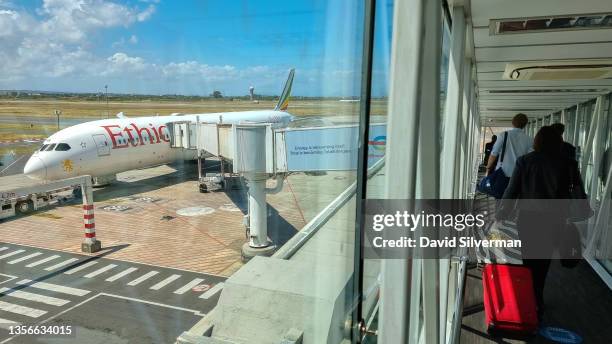 Passengers board Ethiopian Airlines flight ET 846, one of the few international flights leaving the country's second busiest airport after other...