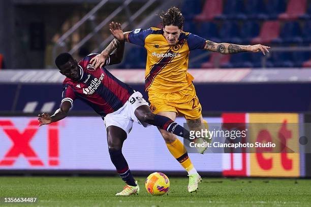 Nicolo Zaniolo of AS Roma competes for the ball with Musa Barrow during the Serie A match between Bologna FC and AS Roma at Stadio Renato Dall'Ara on...