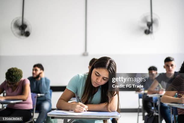 teeanage students doing a test in the classroom - gymnasieexamen bildbanksfoton och bilder