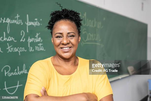 portrait of a teacher in the classroom - teacher stock pictures, royalty-free photos & images