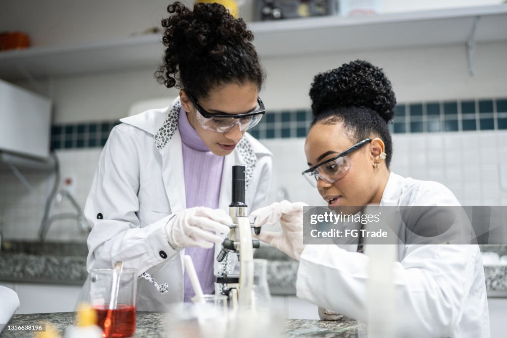 Teenage student using the microscope in the laboratory