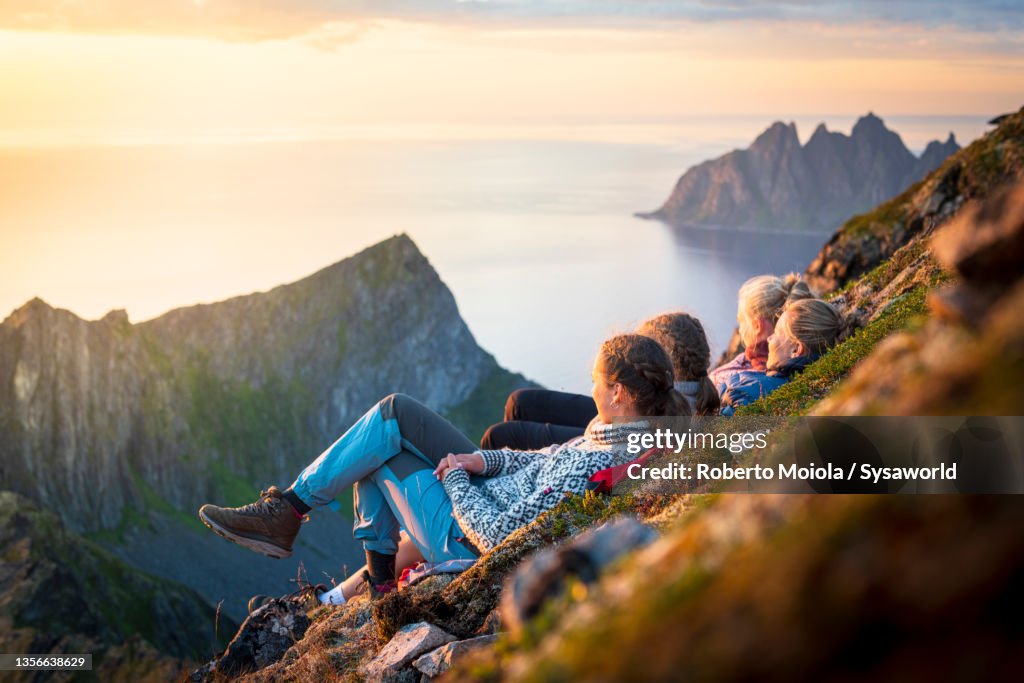 Cheerful young women watching sunset, Senja island, Norway