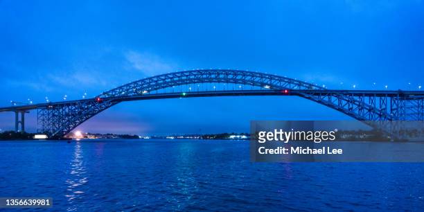 twilight view of bayonne bridge from newark bay - bayonne brücke stock-fotos und bilder