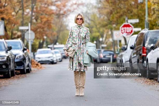 German TV host Tamara von Nayhauss wearing a midi length turtleneck dress with balloon sleeves and pastel floral and animal print by JM Atelier...