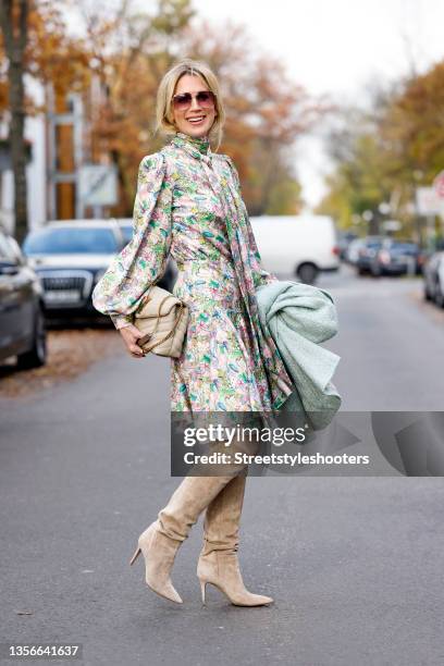 German TV host Tamara von Nayhauss wearing a midi length turtleneck dress with balloon sleeves and pastel floral and animal print by JM Atelier...