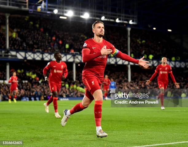 Jordan Henderson captain of Liverpool celebrates after scoring the opening goal during the Premier League match between Everton and Liverpool at...