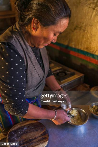 tibetan woman preparing momos, upper mustang, nepal - nepal food stock pictures, royalty-free photos & images