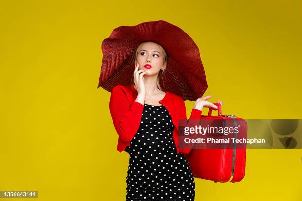 fashionable woman wearing black polka dot dress - wide brim stock-fotos und bilder