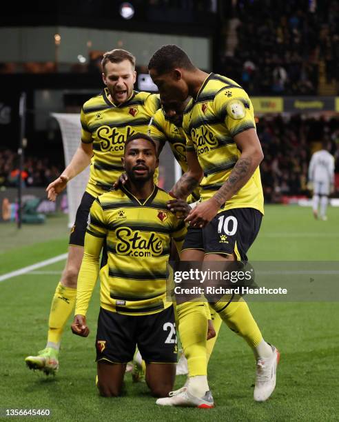 Emmanuel Dennis of Watford FC celebrates with teammates Tom Cleverley and Joao Pedro after scoring their side's first goal during the Premier League...