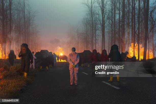 environmental disaster with hazmat team cleaning up - rescue services occupation imagens e fotografias de stock