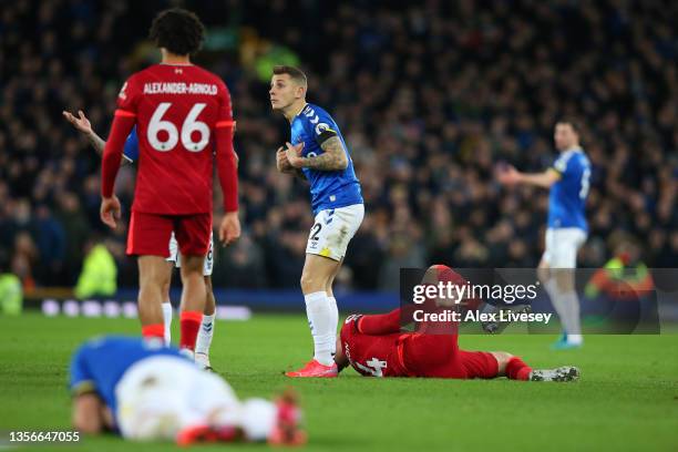 Lucas Digne of Everton reacts as Jordan Henderson of Liverpool goes down injured during the Premier League match between Everton and Liverpool at...