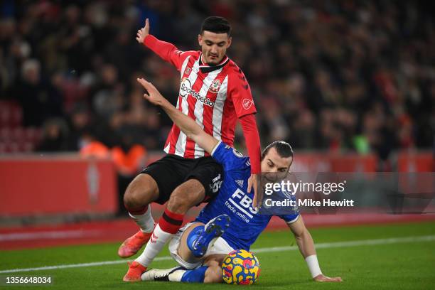 Armando Broja of Southampton is tackled by Caglar Soyuncu of Leicester City during the Premier League match between Southampton FC and Leicester City...