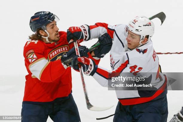 Ryan Lomberg of the Florida Panthers and Martin Fehervary of the Washington Capitals come together at the FLA Live Arena on November 30, 2021 in...