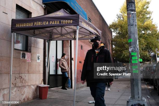 People walk past an East Harlem health clinic that offers free needles and other services to drug users on December 01, 2021 in New York City. New...