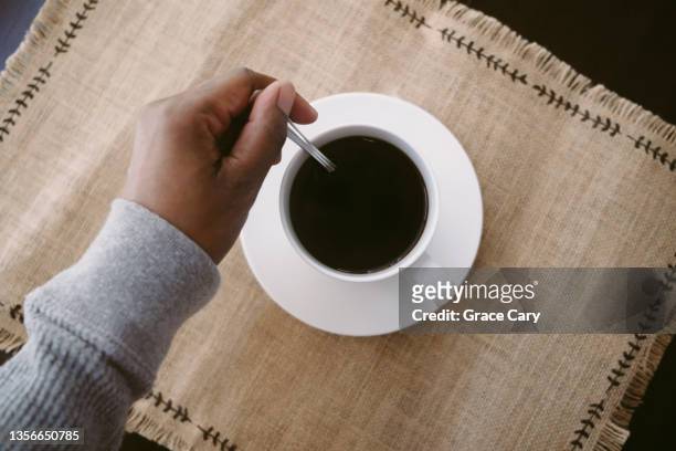 woman stirs cup of coffe - coffee spoon stock pictures, royalty-free photos & images