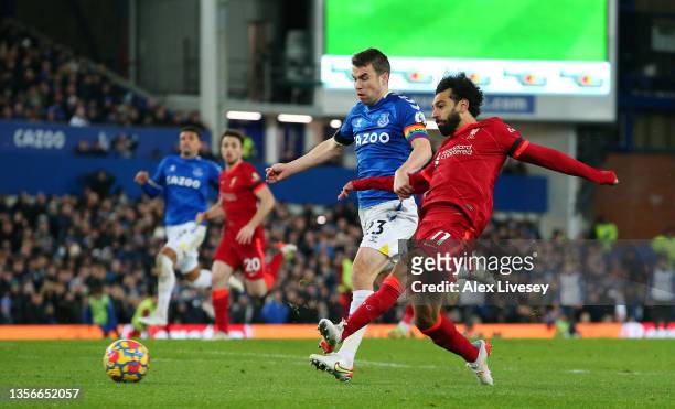 Mohamed Salah of Liverpool scores their side's third goal whilst under pressure from Seamus Coleman of Everton during the Premier League match...