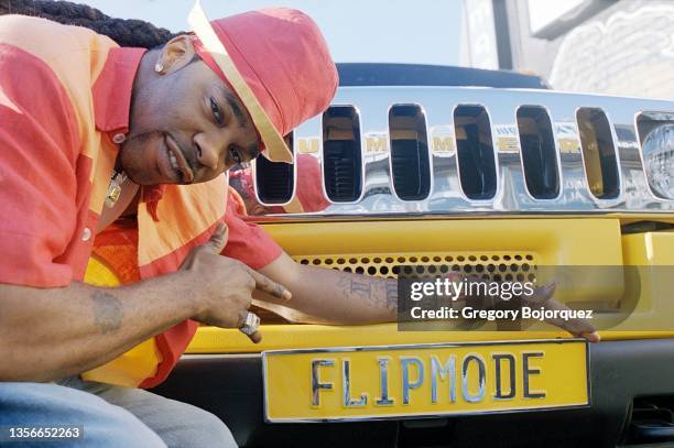 American rapper Busta Rhymes poses with his exotic cars in September, 2002 in Long Island, New York.
