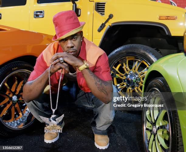 American rapper Busta Rhymes poses with his exotic cars in September, 2002 in Long Island, New York.