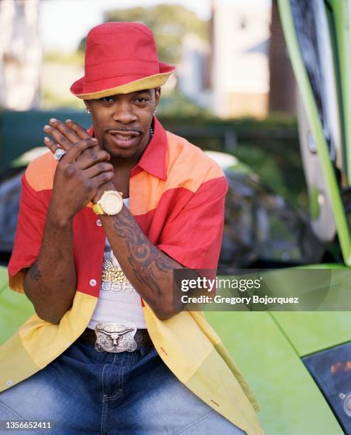 American rapper Busta Rhymes poses with his exotic cars in September, 2002 in Long Island, New York.