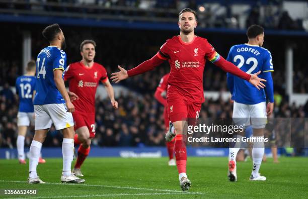 Jordan Henderson of Liverpool celebrates after scoring their side's first goal during the Premier League match between Everton and Liverpool at...