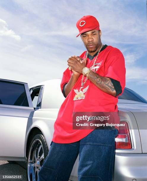 American rapper Busta Rhymes poses with his exotic cars in September, 2003 in Long Island, New York.