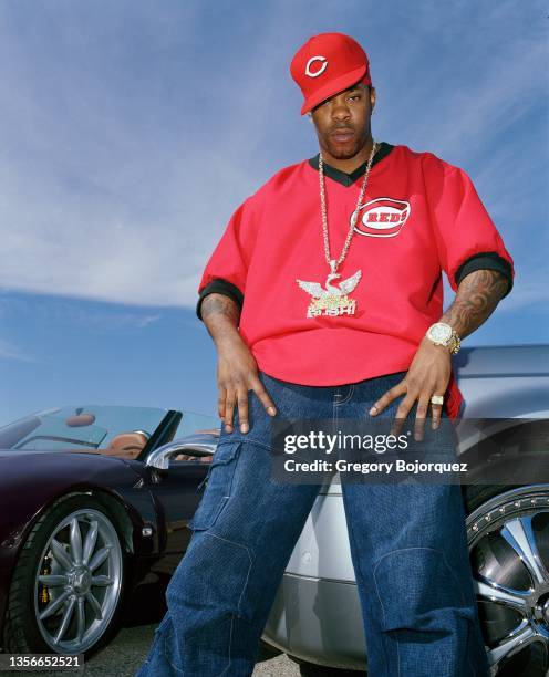 American rapper Busta Rhymes poses with his exotic cars in September, 2003 in Long Island, New York.