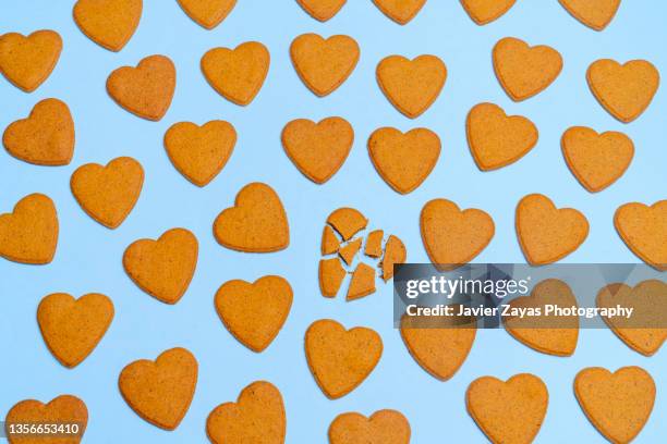 heart shaped ginger cookies on blue background - damaged parcel stock pictures, royalty-free photos & images