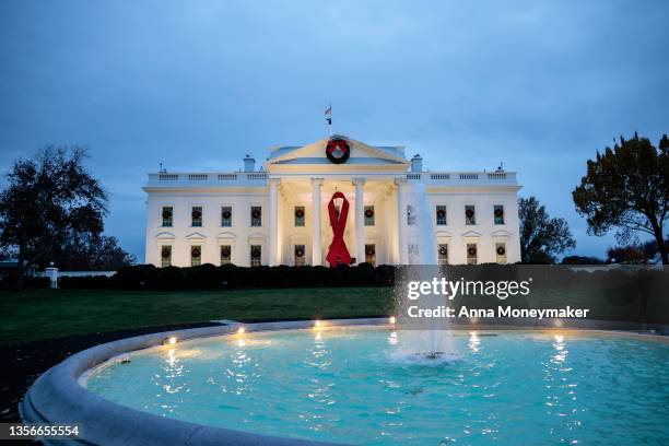 Red ribbon is displayed on the North Portico of the White House to recognize World AIDS Day on December 01, 2021 in Washington, DC. Earlier today...