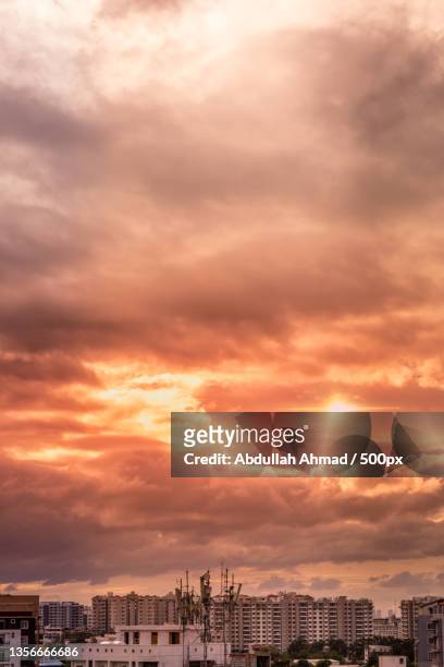 surreal sun,high angle view of buildings against sky during sunset,bengaluru,karnataka,india - dusk stock pictures, royalty-free photos & images