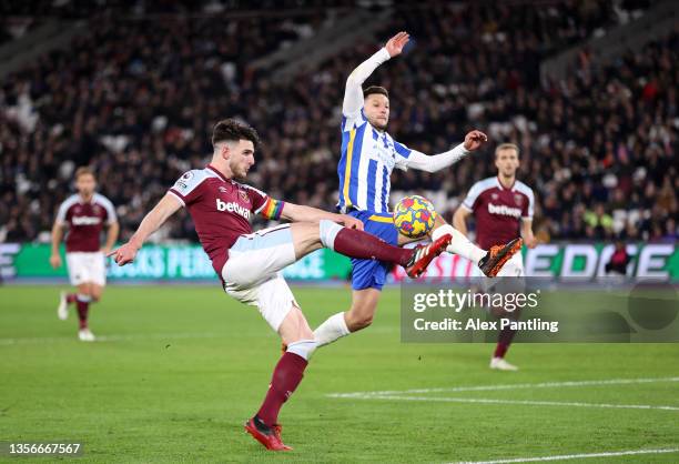 Declan Rice of West Ham United is tackled by Adam Lallana of Brighton during the Premier League match between West Ham United and Brighton & Hove...