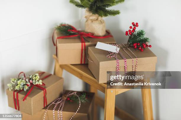 beautiful christmas gift boxes on wooden small ladder in the room. - christmas tree stockfoto's en -beelden