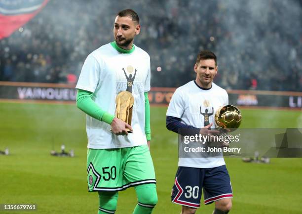 Goalkeeper of PSG Gianluigi Donnarumma holding his Yachine Trophy of best goalkeeper of 2021 and Lionel Messi of PSG holding his 7th Ballon d'Or are...