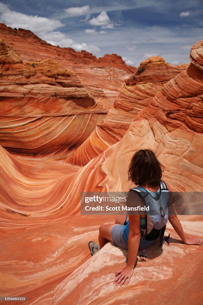 Woman sitting on the edge of The Wave