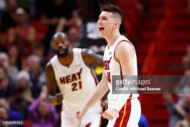 Tyler Herro of the Miami Heat celebrates a three pointer by Max Strus against the Cleveland Cavaliers during the first half at FTX Arena on December...