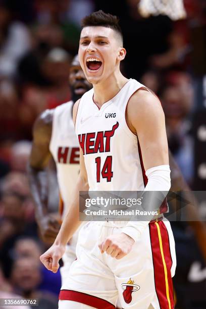 Tyler Herro of the Miami Heat celebrates a three pointer by Max Strus against the Cleveland Cavaliers during the first half at FTX Arena on December...