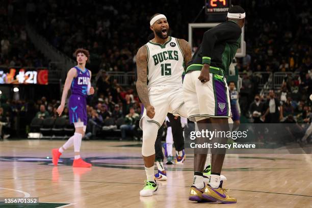DeMarcus Cousins and Bobby Portis of the Milwaukee Bucks celebrate after a three point shot during the second half of a game against the Charlotte...