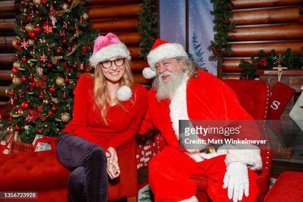 Connie Britton poses for a photo with Santa at the Dodgers Holiday Festival at Dodger Stadium on December 01, 2021 in Los Angeles, California.