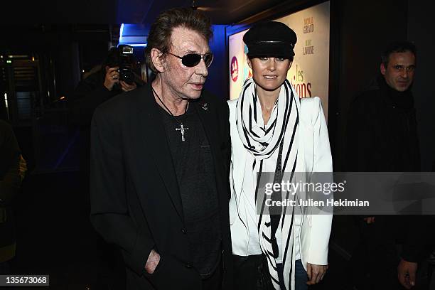 Johnny Hallyday and Laeticia Hallyday attend 'Les tribulations d Une Caissiere' Paris premiere at UGC Cine Cite Bercy on December 12, 2011 in Paris,...