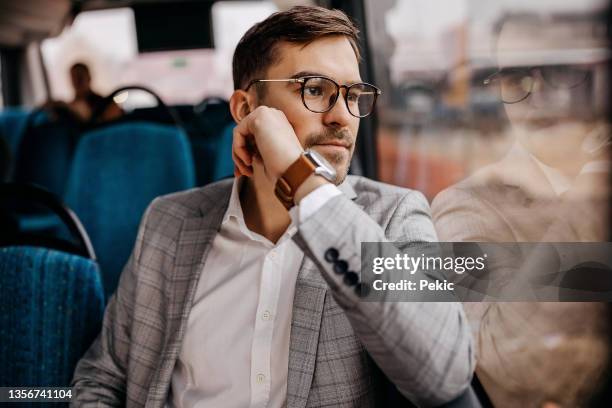 businessman in city bus - bus window stock pictures, royalty-free photos & images