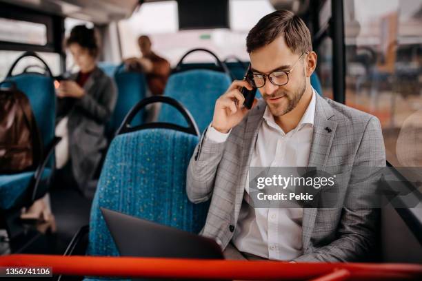 young smiling businessman on city bus - commuting bildbanksfoton och bilder