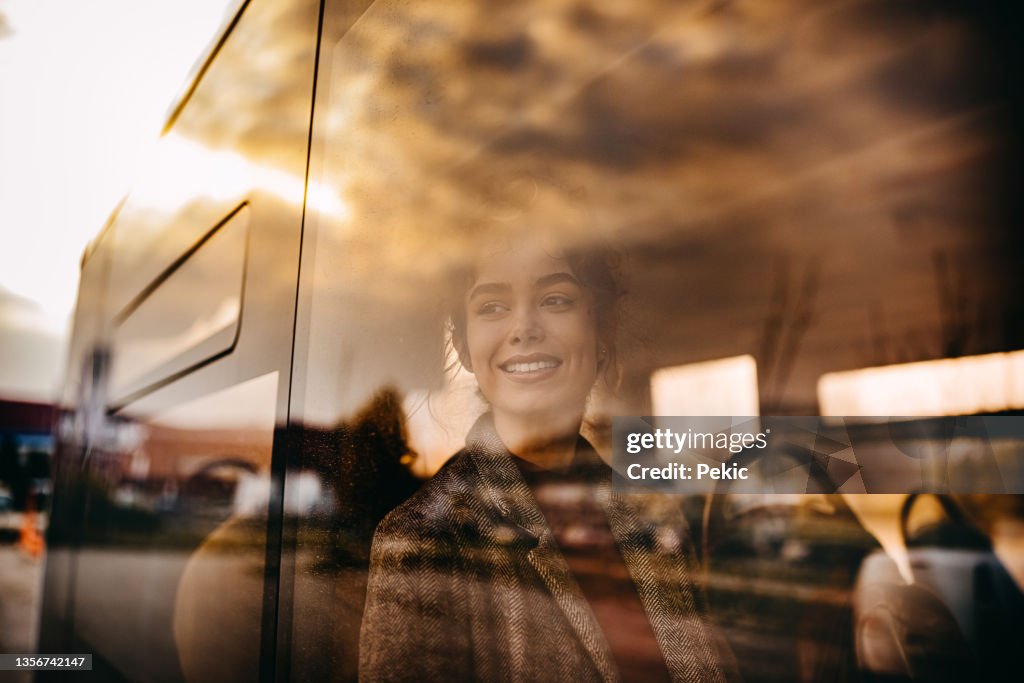 Young beautiful woman riding in public bus